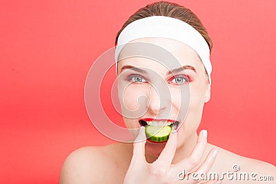 Pretty female biting a slice of cucumber Stock Photo