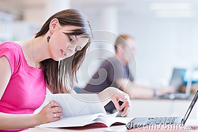Pretty female college student in the library Stock Photo