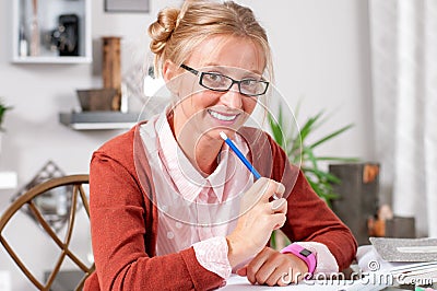 Pretty female student with books working in a high school Stock Photo