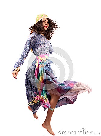 Pretty gipsy lady in retro colorful dress dancing Stock Photo