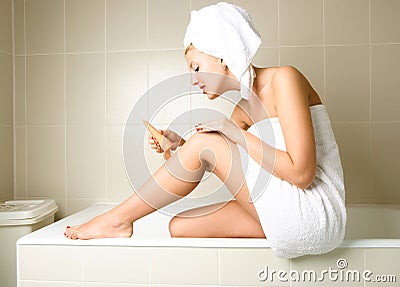 Pretty girl applying body lotion Stock Photo