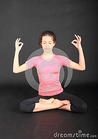 Pretty girl exercising yoga - lotus pose Stock Photo