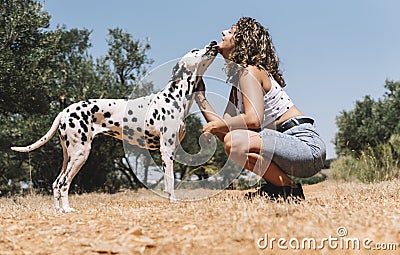 Pretty girl and a happy dalmatian dog Stock Photo