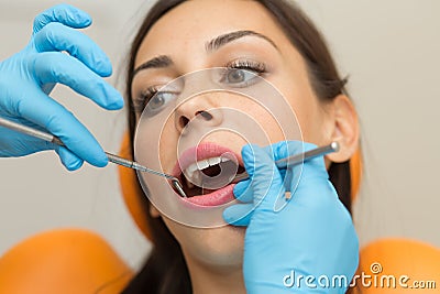 Pretty girl having mouth checkup in hospital by professional female dentist Stock Photo