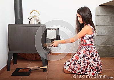 Pretty girl heating up in heater Stock Photo
