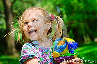 Pretty girl holding new toys for sandbox outdoor Stock Photo