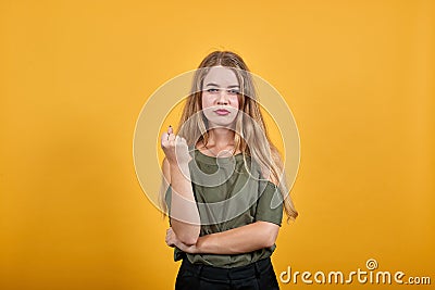 Pretty girl keeping fists up, looking angry wearing nice haki shirt Stock Photo