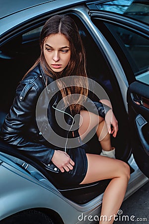 Pretty girl exiting car Stock Photo