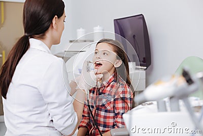 Pretty girl looking at her favorite doctor Stock Photo