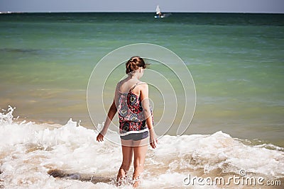 A pretty girl playing in the waves on the beach, soft focus, beach concept Stock Photo