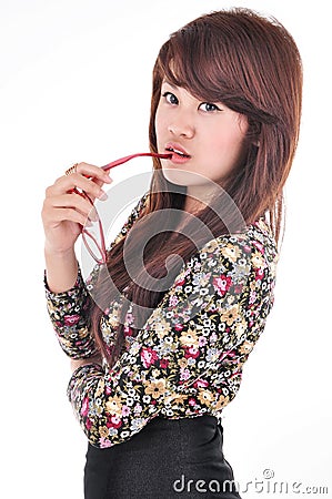 Pretty girl posing and biting glasses Stock Photo