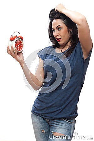 Pretty girl scared looks at the clock, studio, isolated Stock Photo