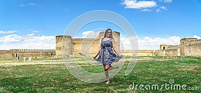 A pretty girl in a skirt on the background of panoramas of the fortress Stock Photo