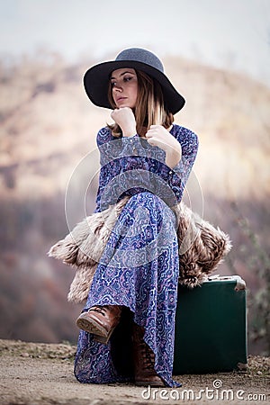 Pretty girl with vintage case on a dirtroad Stock Photo