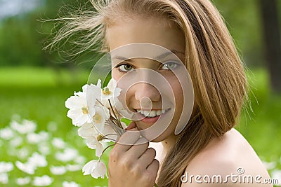 Pretty girl with white bouquet near the face Stock Photo