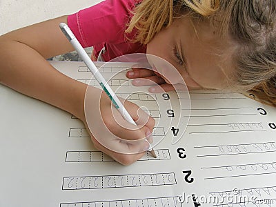 Pretty girl writening math homework Stock Photo