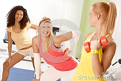 Pretty girls exercising with dumbbells Stock Photo