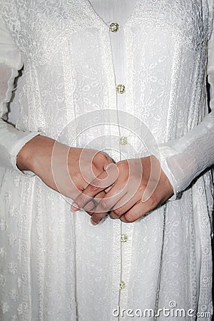 Pretty hands of a lady or woman wearing white dress or fashion or style Stock Photo