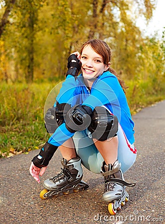 Pretty happy girl with rollerskates Stock Photo