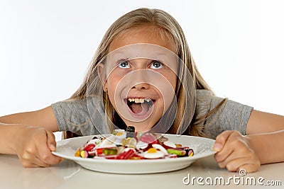 Sugar high young blonde girl eating too much sugar in nutrition concept Stock Photo