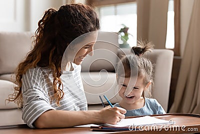 Pretty happy woman engaged in early child education. Stock Photo