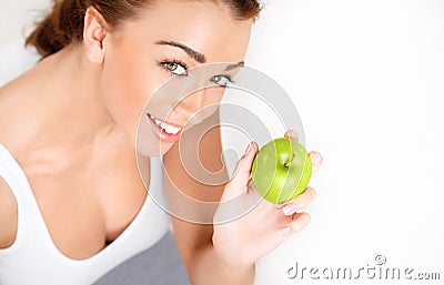 Pretty healthy young woman smiling holding a green apple Stock Photo