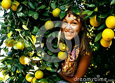 Pretty islam woman in orange grove smiling, real muslim girl che Stock Photo