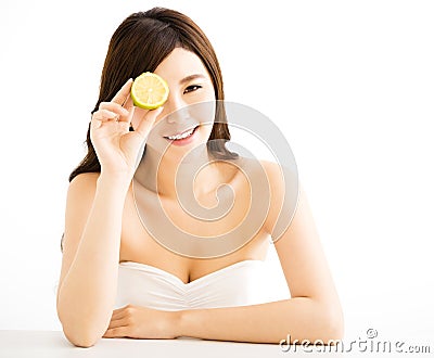 Pretty joyful young woman holding lemon Stock Photo