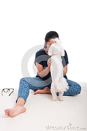 Pretty lady relaxing with her fluffy bichon Stock Photo