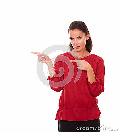 Pretty latin woman pointing to her right Stock Photo