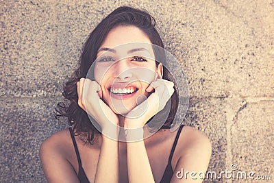 Pretty laughing caucasian woman with long dark hair Stock Photo