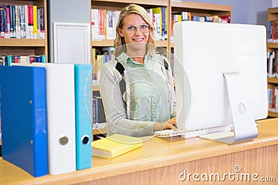 Pretty librarian working in the library Stock Photo