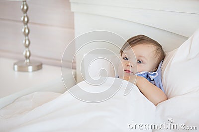 Pretty little baby girl lies in a bed Stock Photo