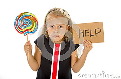 Pretty little child holding lollipop and help sign in children sugar excess Stock Photo