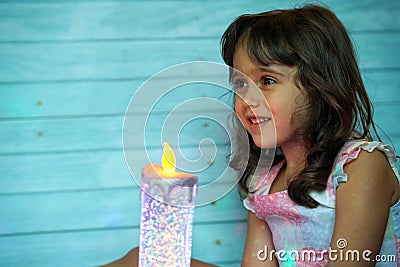 Pretty little girl with big eyes looks with interest from the side Stock Photo