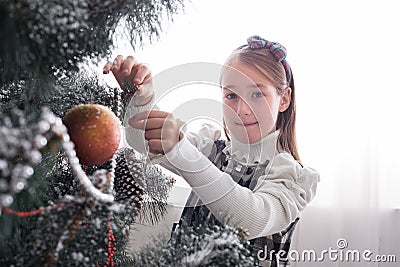 Pretty little girl decorate big christmas tree Stock Photo