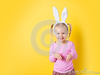 Pretty little girl easter bunny on yellow background Stock Photo