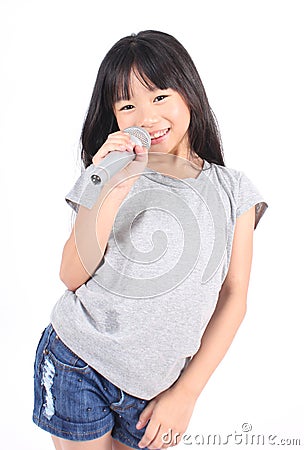 Pretty little girl with the microphone in her hand Stock Photo