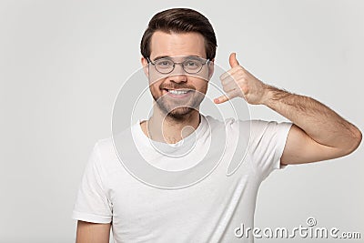 Guy showing call me back gesture with hand studio shot Stock Photo