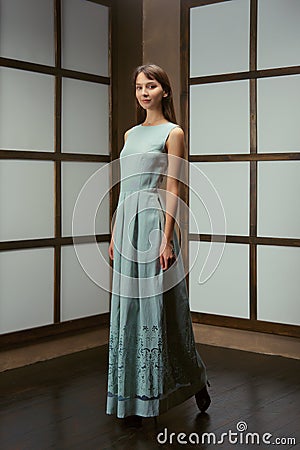 Pretty model demonstrating outfit - long cotton dress and jeans jacket Stock Photo