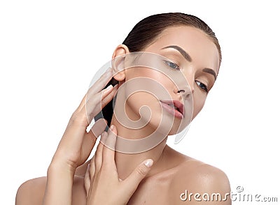 Pretty model with wonderful facefeatures posing touching her neck tenderly. Stock Photo