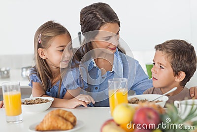 Pretty mother having breakfast with her children Stock Photo