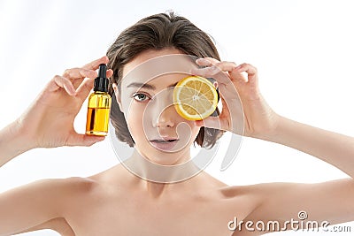 Pretty naked female with lemon and oil bottle Stock Photo