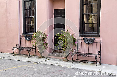 Pretty pink building and benches Stock Photo