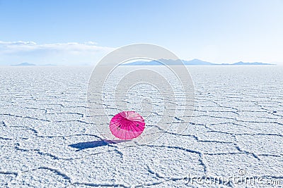 Pretty pink parasol set on the Uyuni salt flat salar de Uyuni Stock Photo