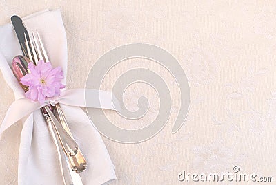 Pretty Place Setting with Fork, Knife, spoon, cherry blossom on Cream Tablecloth Stock Photo
