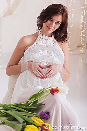 Pretty pregnant woman with tulip flowers Stock Photo