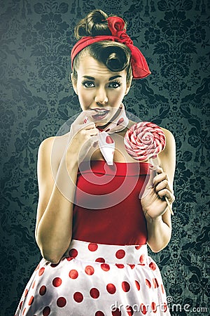 Pretty woman in red vintage polka dot dress - with lollipop Stock Photo