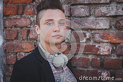 Pretty short hair girl posing against a brick wall Stock Photo