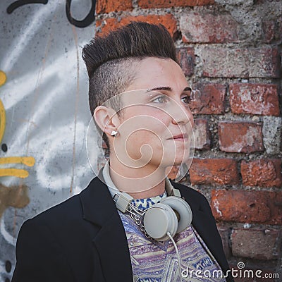 Pretty short hair girl posing against a wall Stock Photo